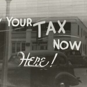 a sign that says pay your tax now here