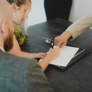 a woman showing a man something on a tablet